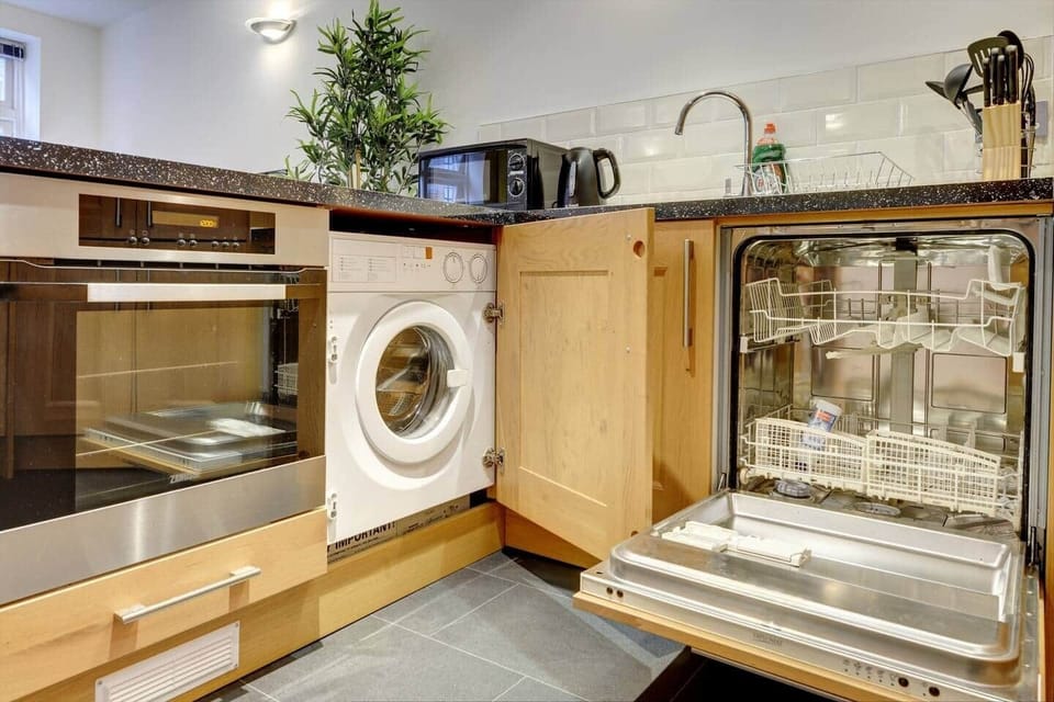 The kitchen has a contemporary and stylish aesthetic that seamlessly integrates with the overall ambiance of the house. Clean lines, minimalist decor, and high-quality materials create an inviting space that is both visually striking and practical.