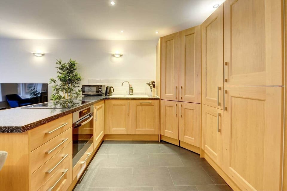 The kitchen has a contemporary and stylish aesthetic that seamlessly integrates with the overall ambiance of the house. Clean lines, minimalist decor, and high-quality materials create an inviting space that is both visually striking and practical.