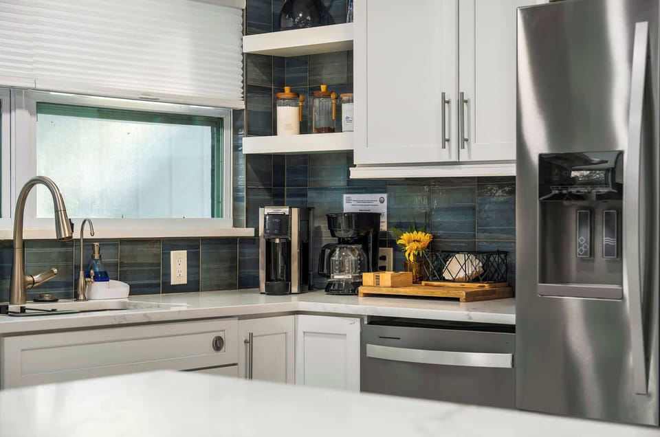 Cook with ease in this fully equipped, modern kitchen featuring stainless steel appliances, sleek countertops, and thoughtful touches throughout. Perfect for preparing meals, morning coffee, or entertaining with friends.