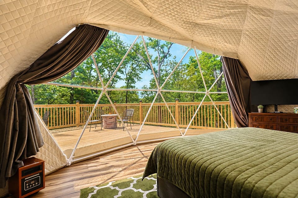 Wake up to green forest views from bed