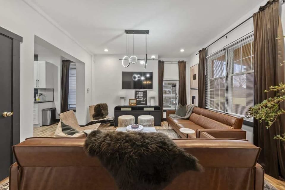 Spacious living room w/ warm tones, inviting sofas & an open layout made for connection and comfort ️