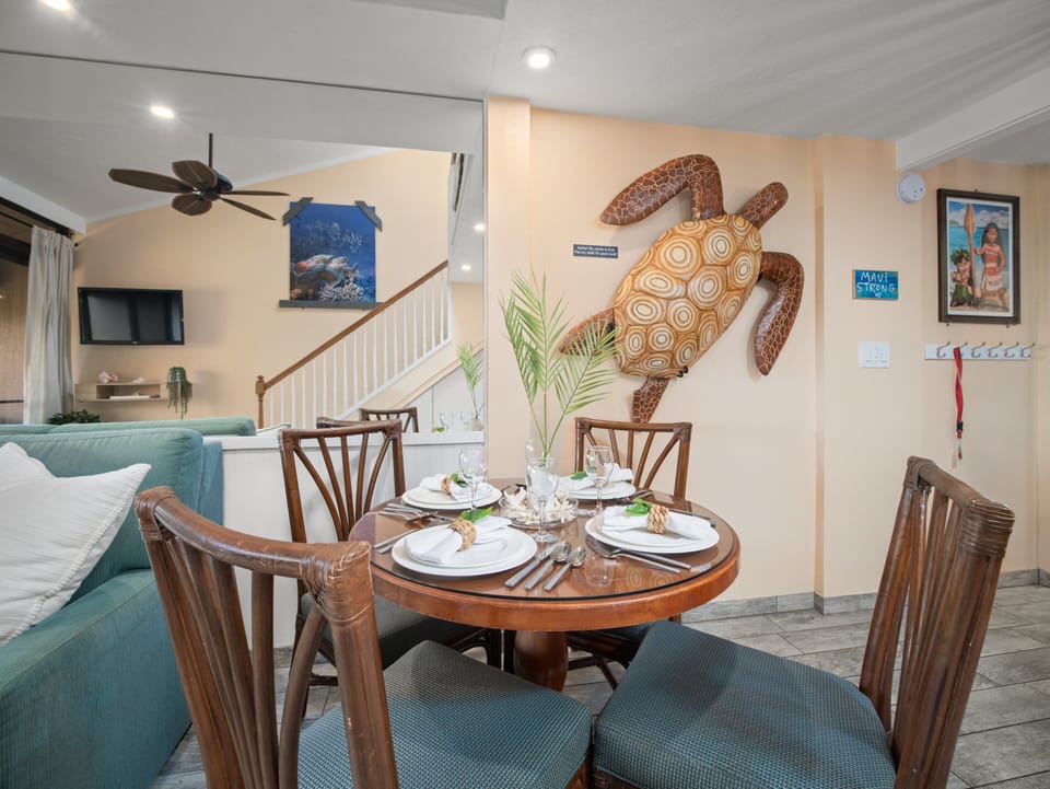 Gather around the inviting dining area accented with Hawaiian décor, ideal for shared meals before heading out to nearby beaches and sunset activities.