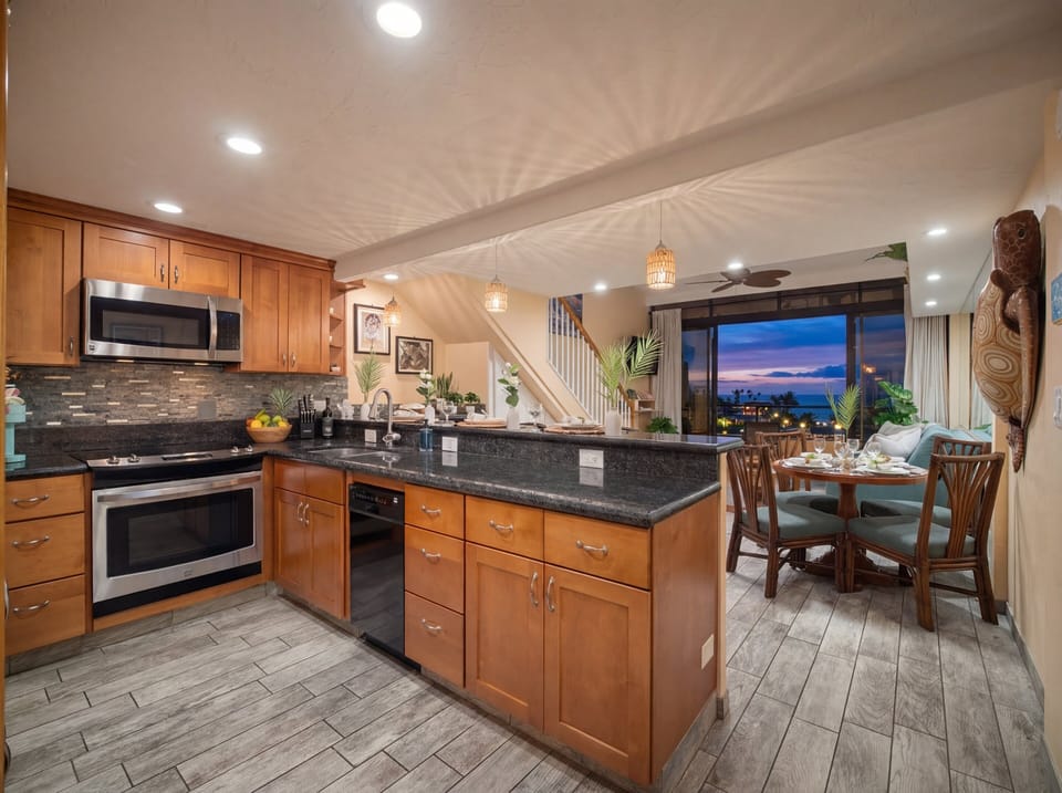 Enjoy warm evening ambiance in the kitchen and dining space, beautifully lit for relaxed dinners after exploring Maui's beaches, snorkeling spots, and local attractions.