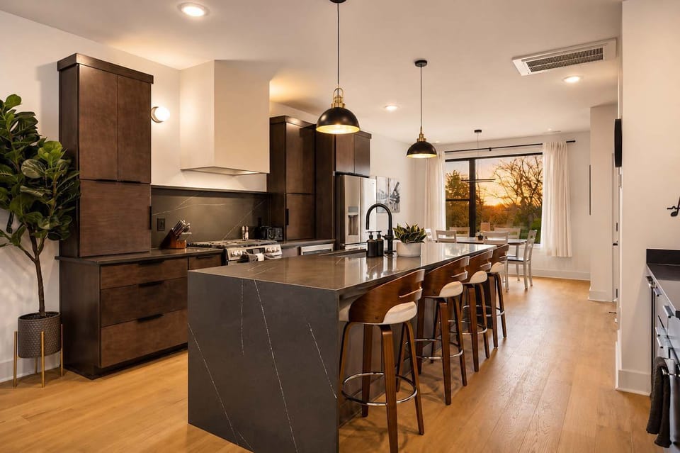 Kitchen: Sleek lines, warm tones, and high-end touches — the perfect kitchen for cooking, entertaining, and enjoying life together.