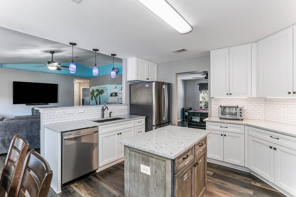 Beautifully updated kitchen with stainless steel appliances and tile backsplash