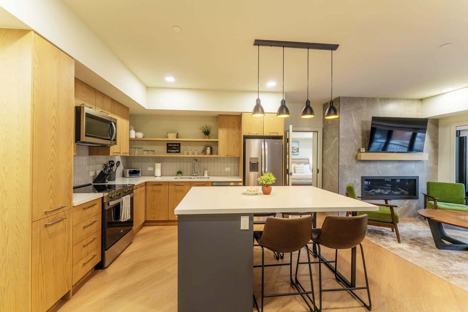 Versatile kitchen island doubles as a dining area with seating for up to 6