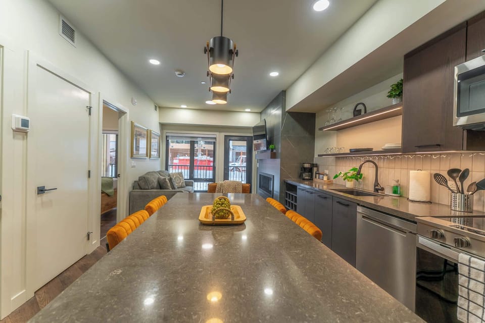 Versatile kitchen island doubles as a dining area for 4