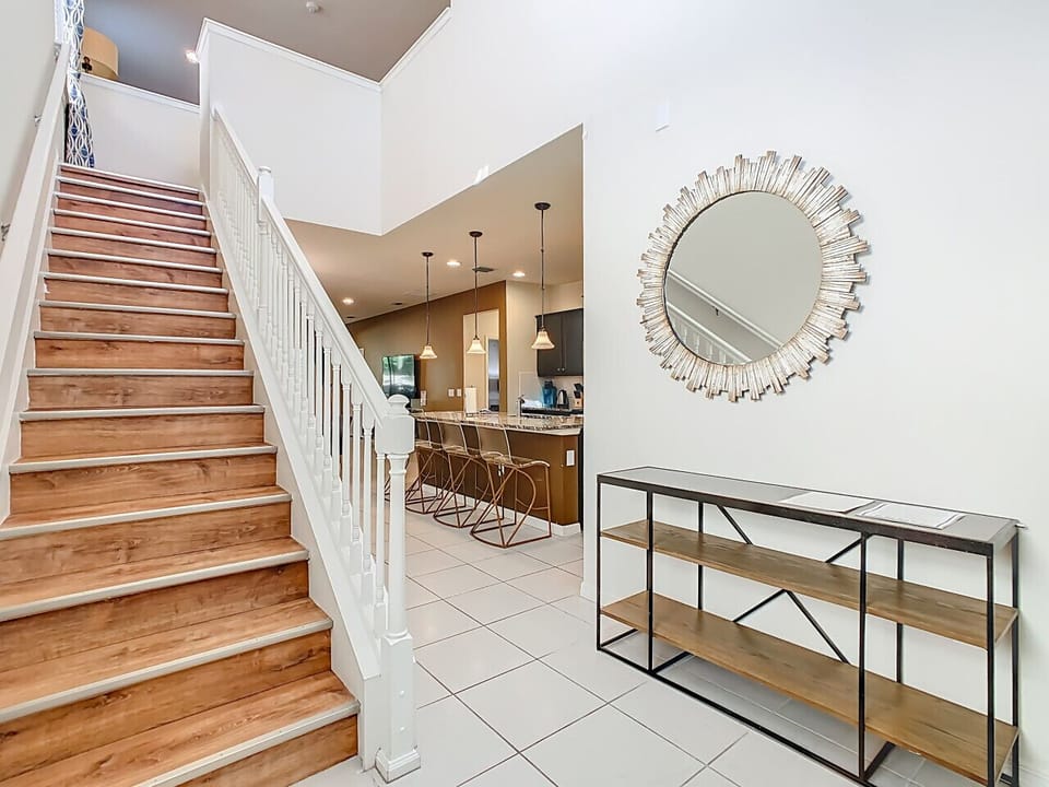 Stylish entryway with staircase, console table, and modern décor