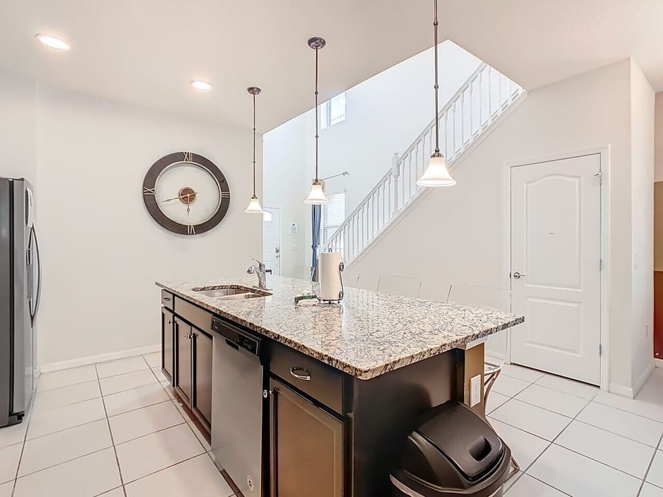 Spacious kitchen island with granite countertops and bar seating