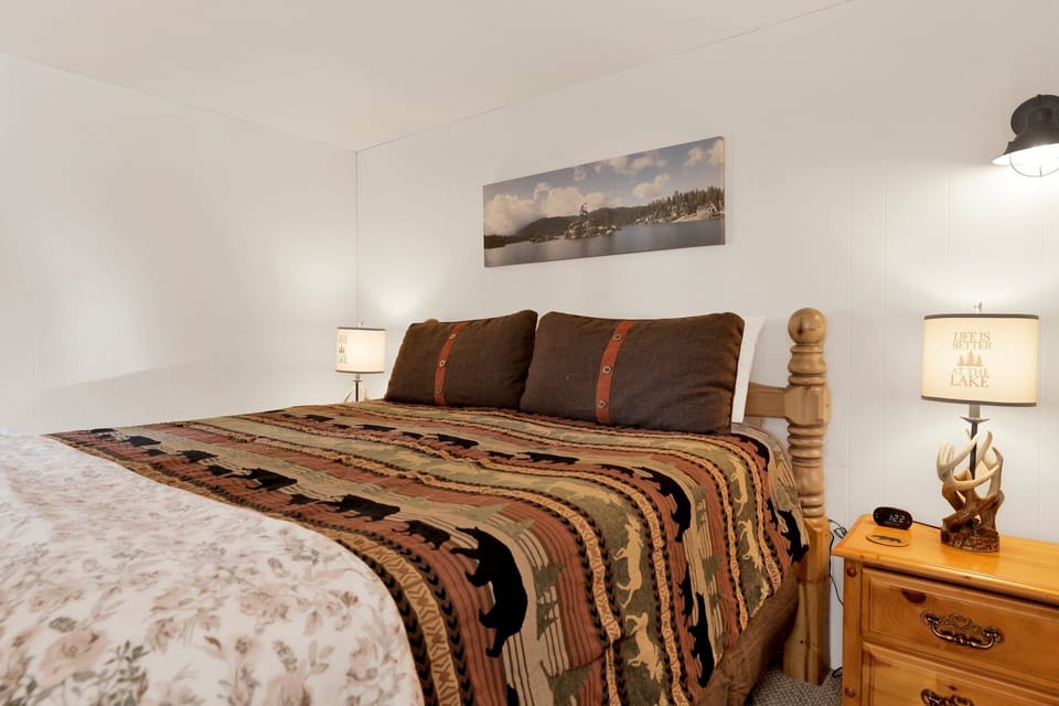 Peaceful cabin bedroom with plush bedding, and beautiful views—ideal for restful nights, cozy mornings, and a relaxing mountain escape.
