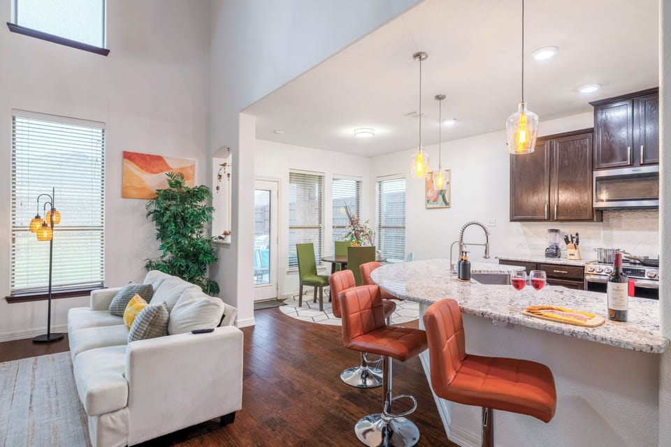 Bright open-concept living with granite kitchen and stylish bar seating
