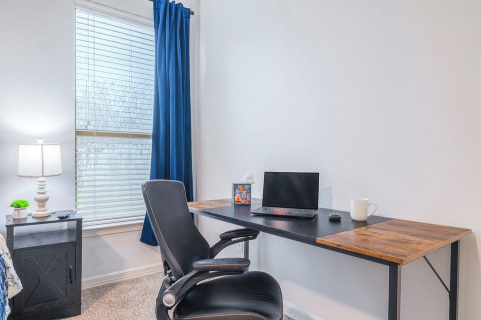 Bright in-room workspace with large desk and natural light