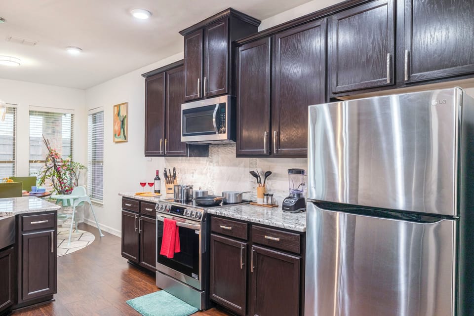 Modern kitchen with stainless appliances and sunny breakfast nook