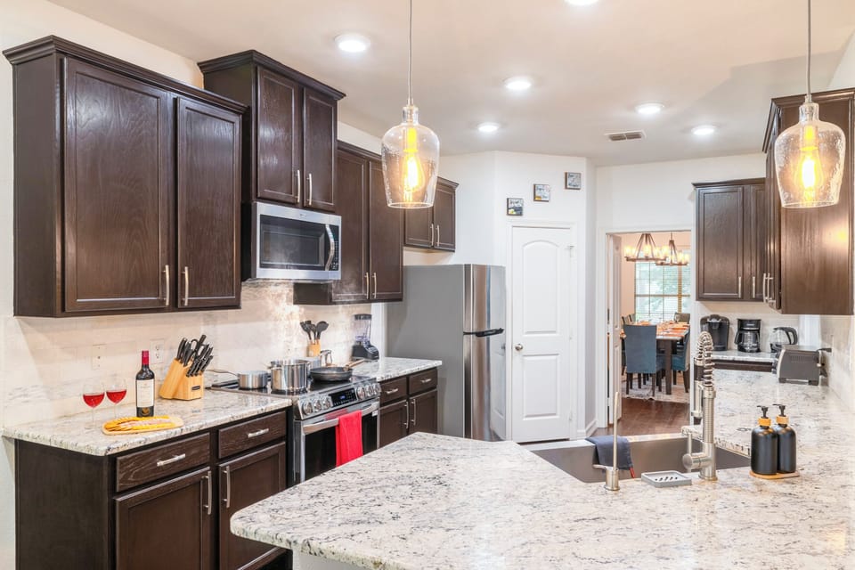 Bright modern kitchen with granite island and stainless appliances