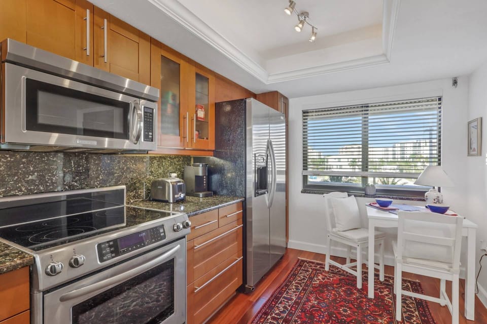 Cookware, dinnerware, kitchen tools and small appliances are provided, including a Keurig coffee maker.