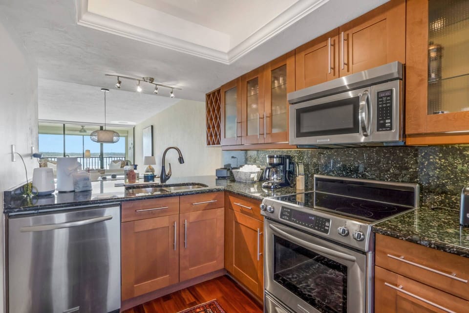 The well appointed kitchen features upgraded appliances, granite counters abundant cabinetry.