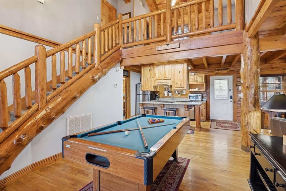 Main floor game room —featuring a pool table and arcade game for hours of family fun!