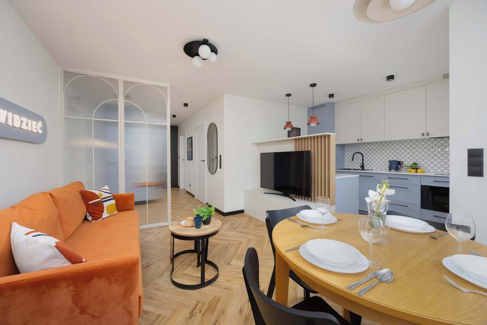 The elegant living room featuring a double sofa bed, perfect for relaxing or sleeping.