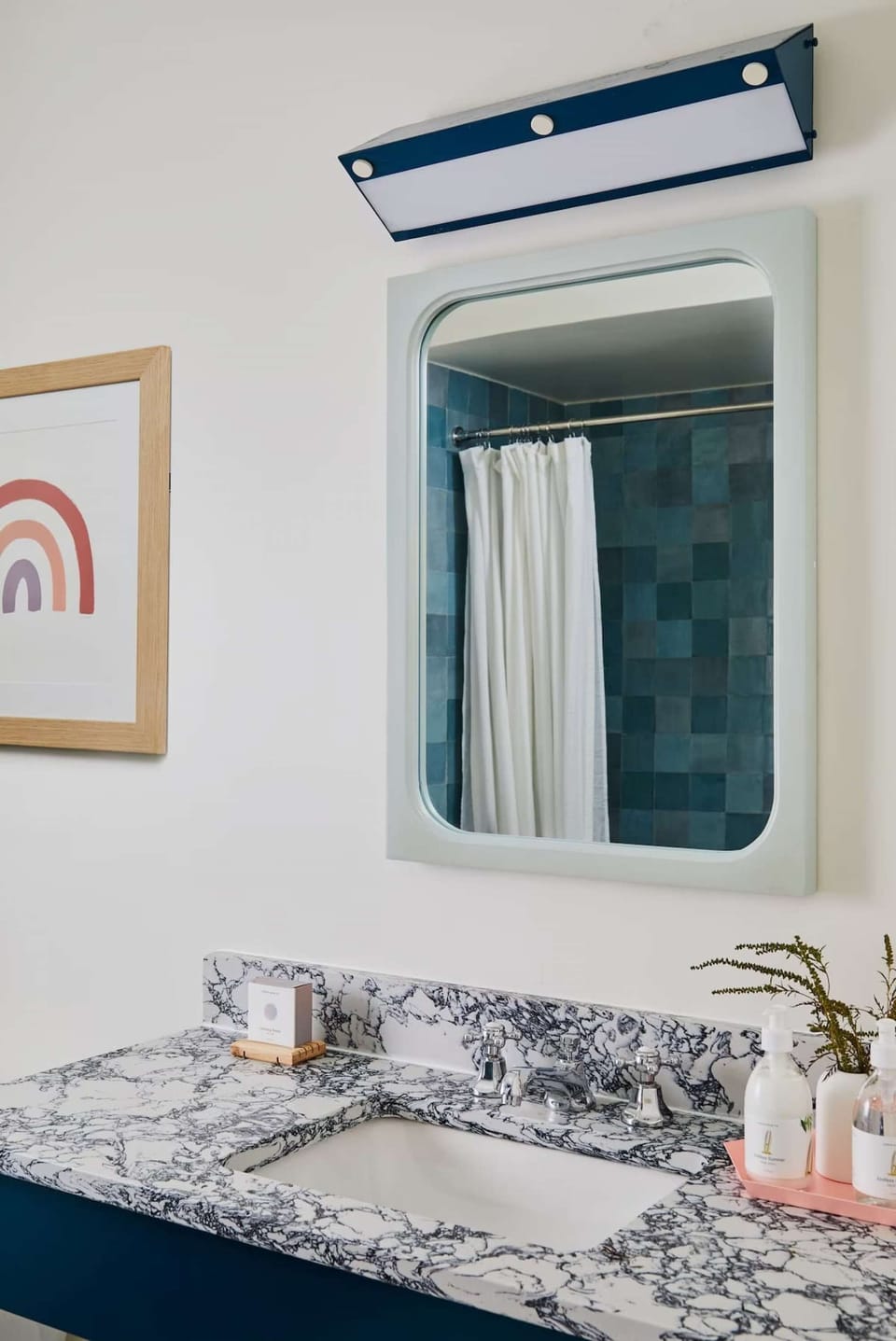 Clean sink area with marble counter and mirror