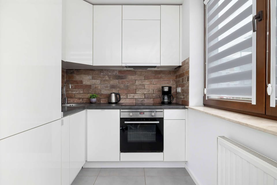 Fully equipped kitchen with white cabinets and ample counter space.