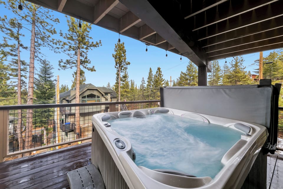 Soak in your private hot tub surrounded by towering pines and mountain views, creating the perfect alpine retreat.