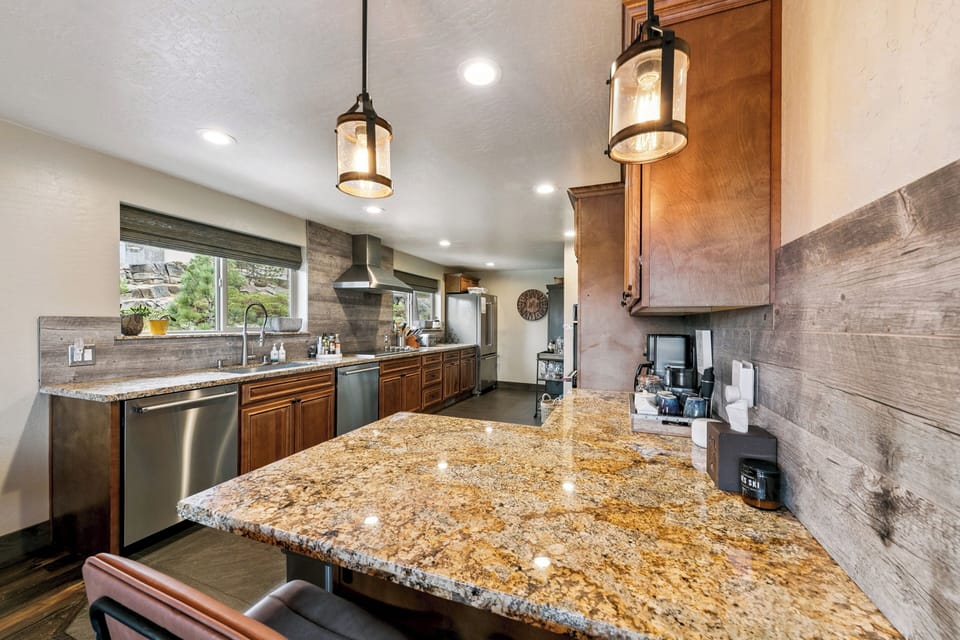 Your gourmet kitchen features granite countertops, warm wood cabinetry, and modern appliances where you'll create memorable meals together.