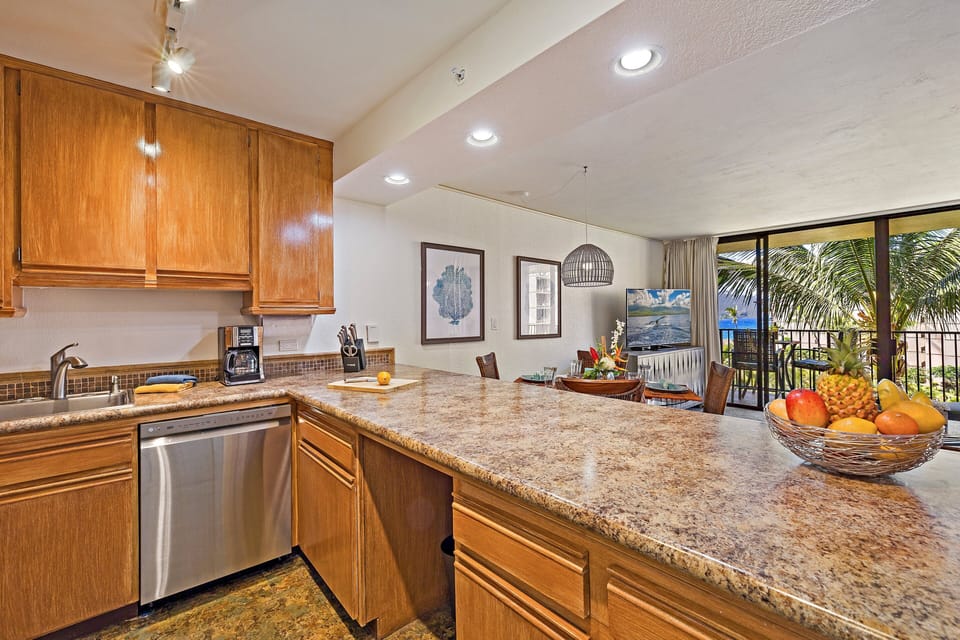 Expansive granite breakfast bar providing plenty of counter space and a clear view into the main living areas.