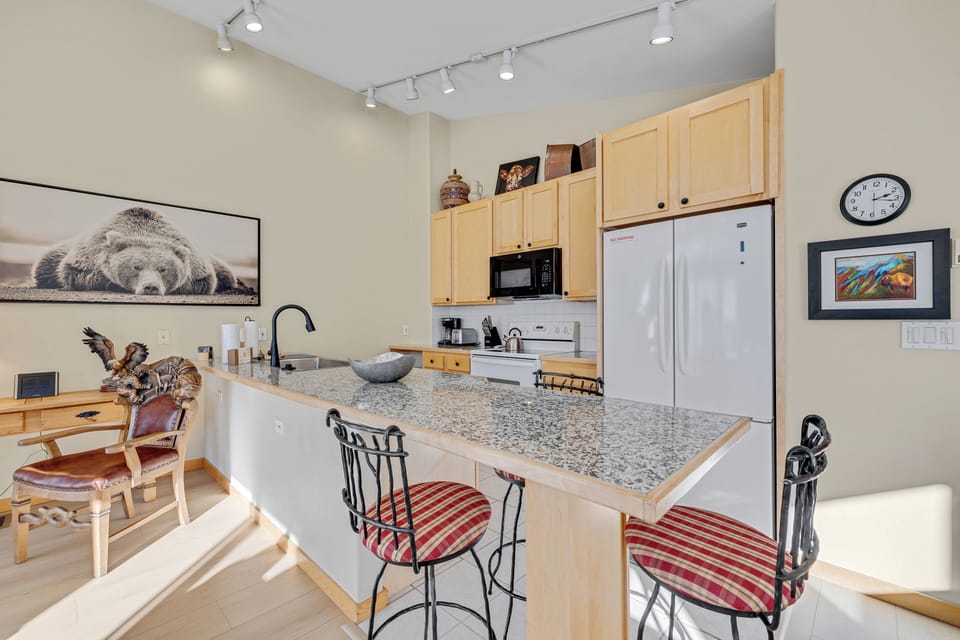 Your fully equipped kitchen awaits with granite counters and breakfast bar where you can enjoy morning coffee while planning adventures.