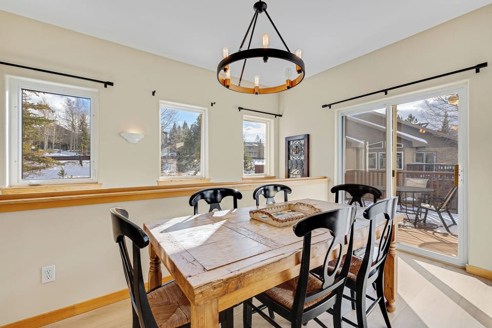 Your dining space features rustic charm with mountain views and deck access for memorable meals.