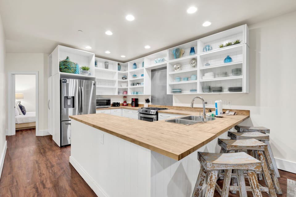 The kitchen features modern appliances, ample counter space, and a breakfast bar perfect for morning coffee or casual meals.