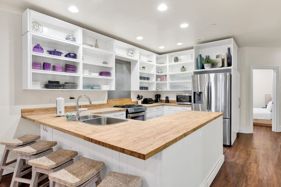 The kitchen features modern appliances, ample counter space, and a breakfast bar perfect for morning coffee or casual meals.