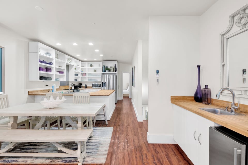 The living room has a wet bar with sink, standalone ice maker and mini fridge