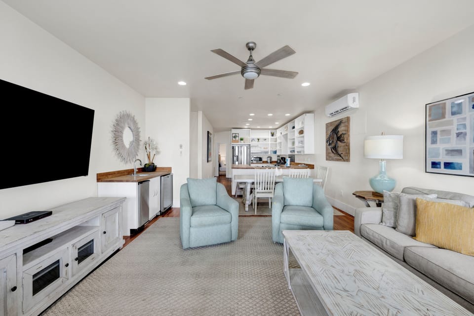 The living room has a wet bar with sink, standalone ice maker and mini fridge