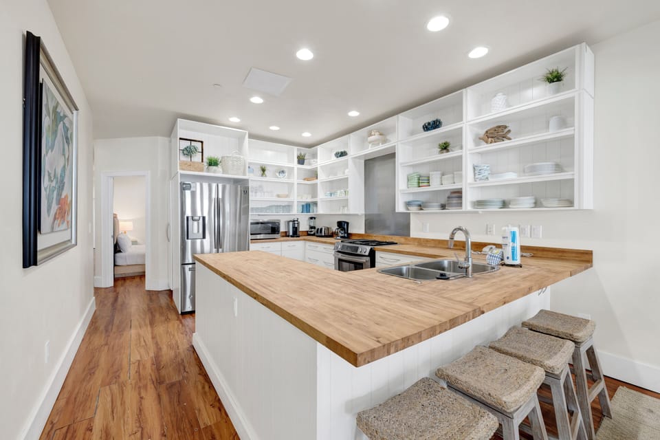 The kitchen features modern appliances, ample counter space, and a breakfast bar perfect for morning coffee or casual meals.