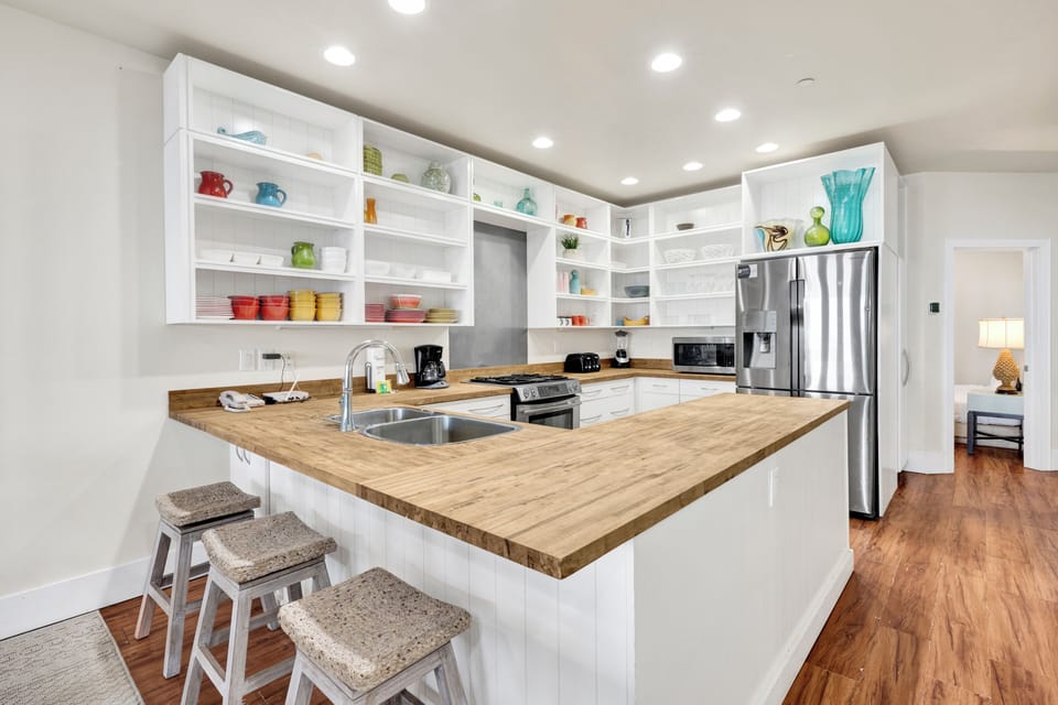 The kitchen features modern appliances, ample counter space, and a breakfast bar perfect for morning coffee or casual meals.