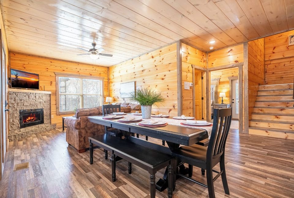 Gather around your rustic dining table while the fireplace crackles nearby, creating the perfect atmosphere for memorable meals together.