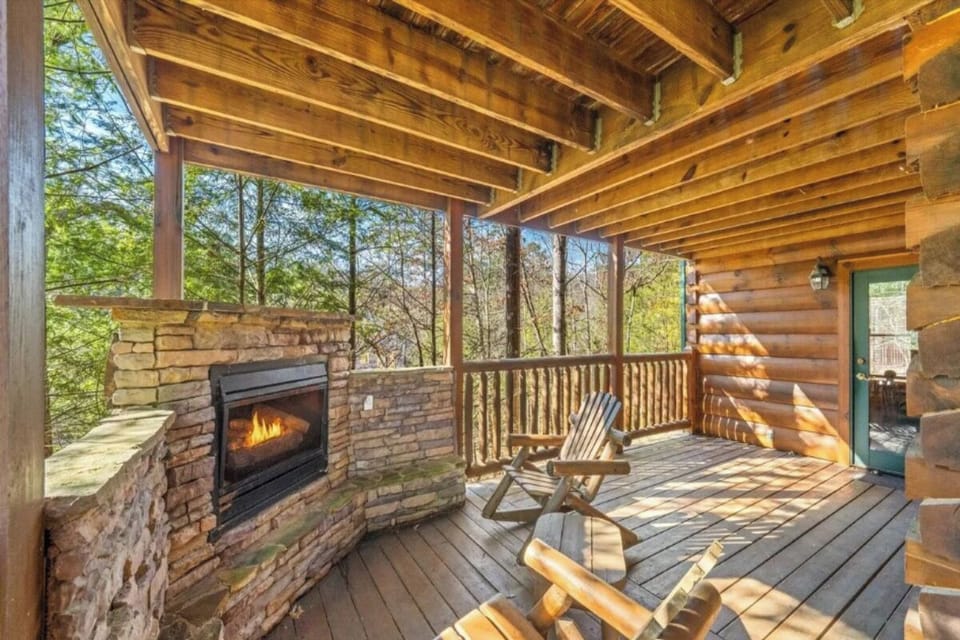 Unwind on your private covered deck where natural forest views meet cozy fireplace warmth and rustic wood beam charm.