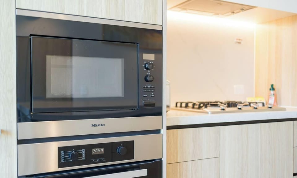 Built-in oven and microwave with sleek cabinetry.
