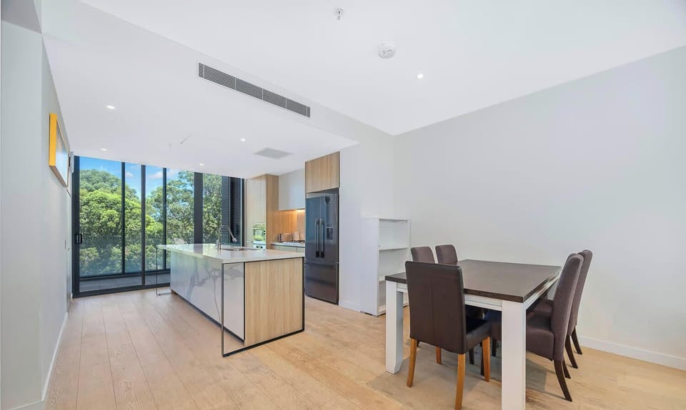 Open-plan living and dining area connected to the kitchen and outdoor space.