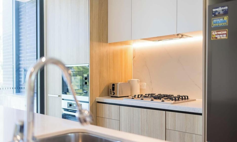 Kitchen close-up with sink, gas cooktop, and quality appliances.