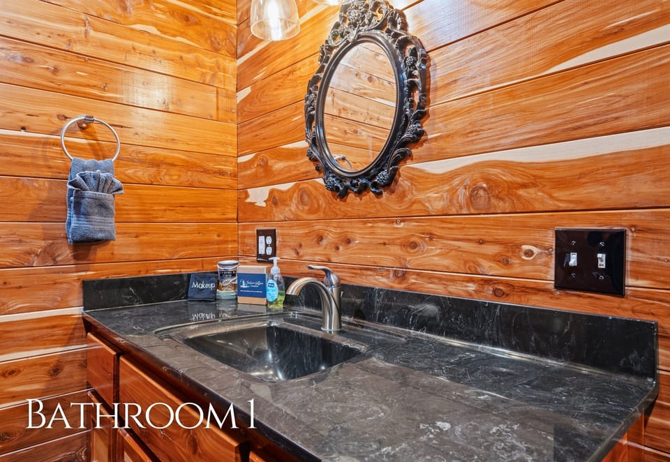 Finished with rustic touches, this bathroom includes a wide vanity and ample space for getting ready with ease.