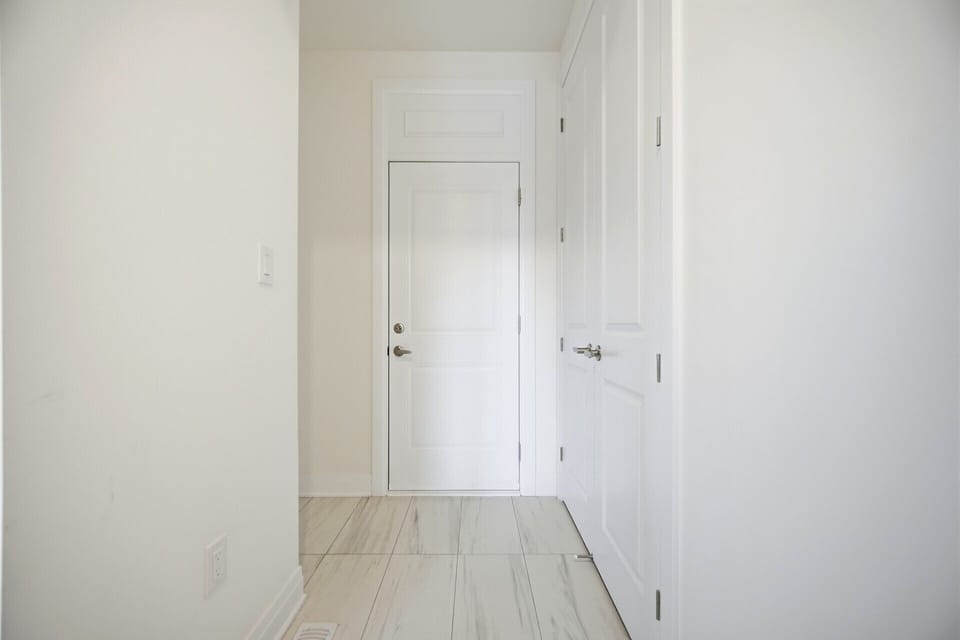 Pristine, well-lit hallways lead to private sleeping areas.
