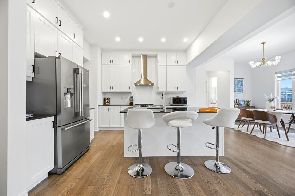 Chef's kitchen: Quartz counters, stainless steel appliances, island.