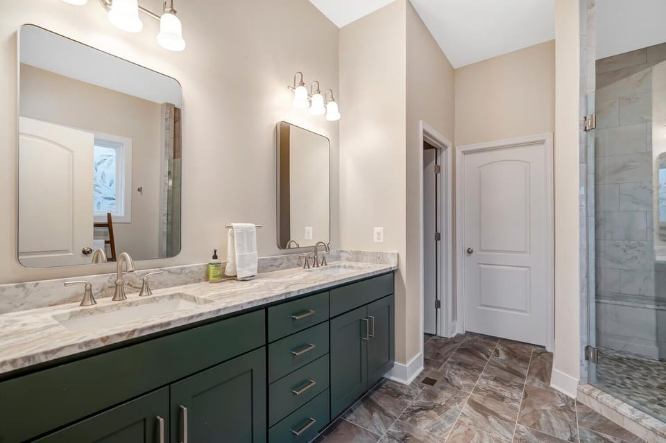 Full Bathroom 1: Modern bathroom with dual sinks and a spacious walk-in shower. 