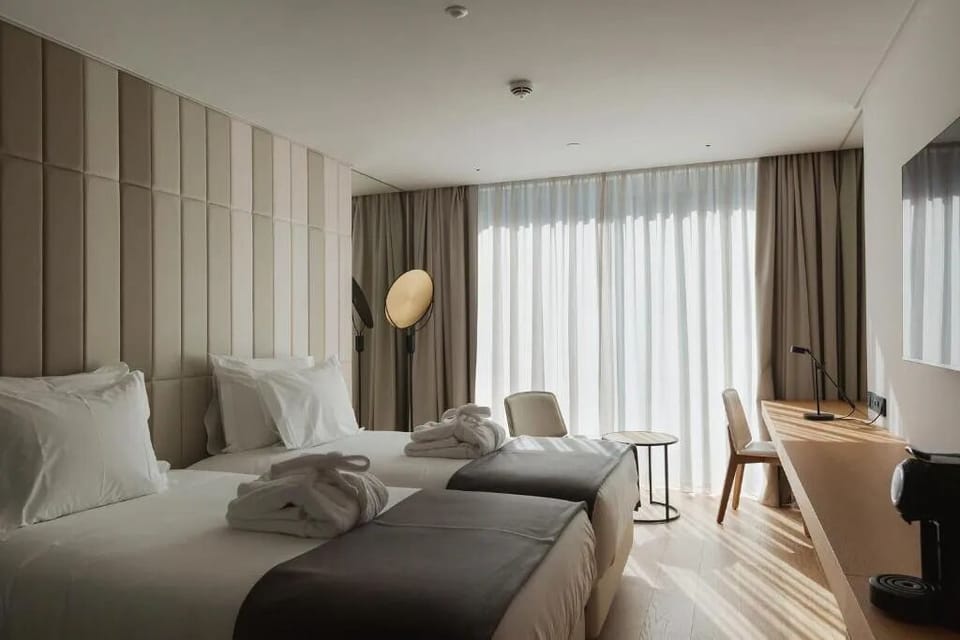 Wake up in sunlit comfort with crisp linens and workspace.
