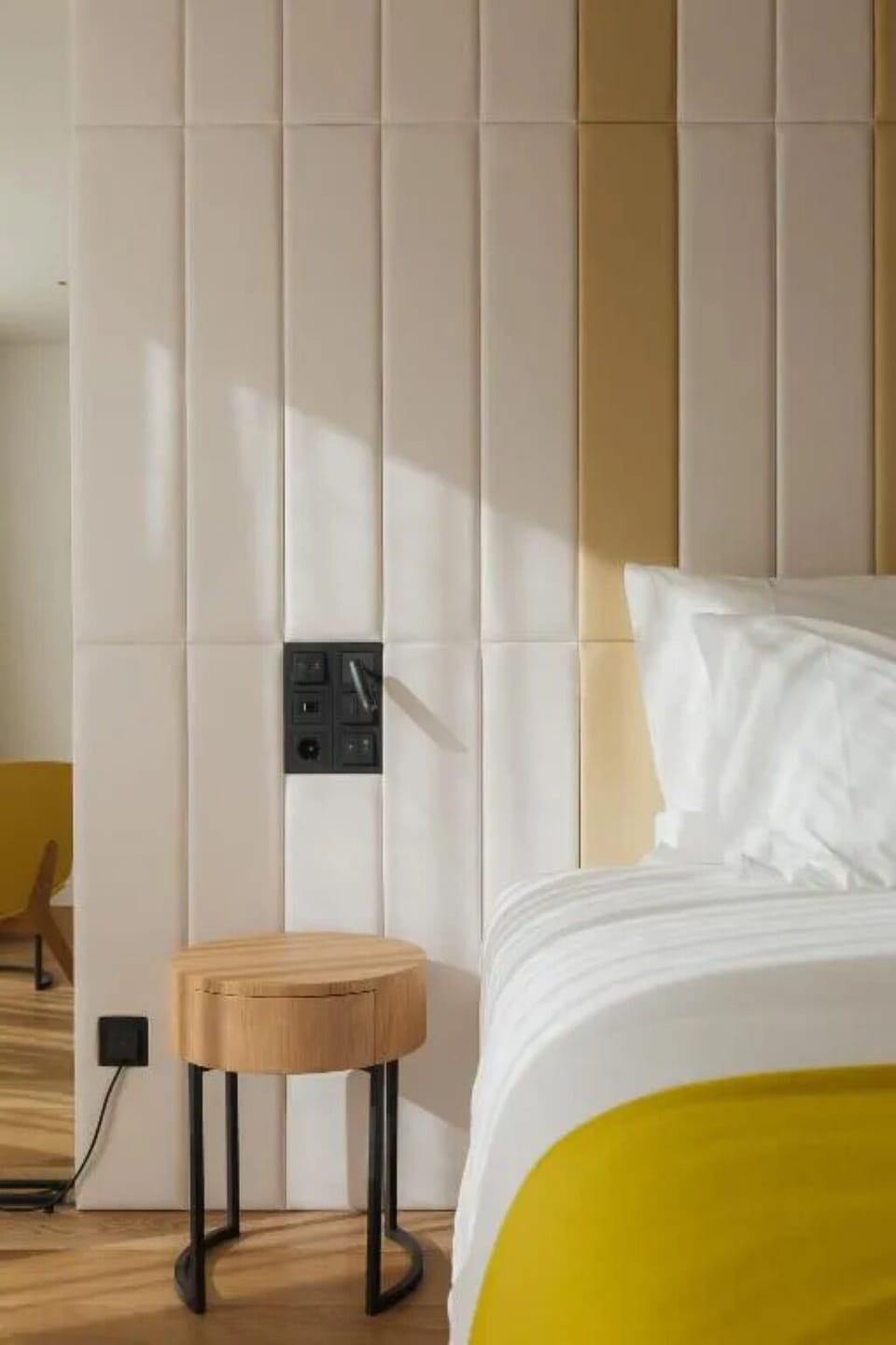 Wake up gently with golden light across the padded headboard.