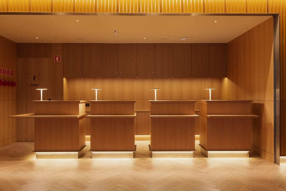 Arrive to a warm, polished lobby with serene lighting.