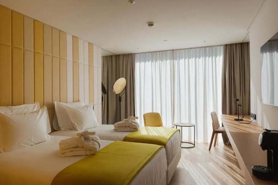 Share a sunlit twin room with hotel-fresh comfort and space.