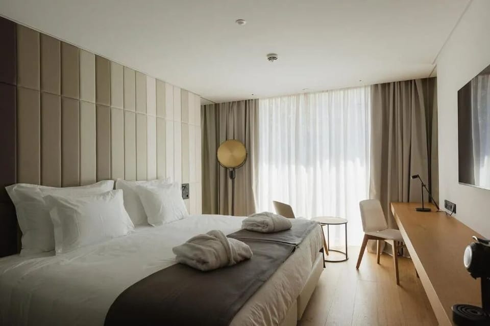 Unwind in a bright, modern bedroom with cozy robes.
