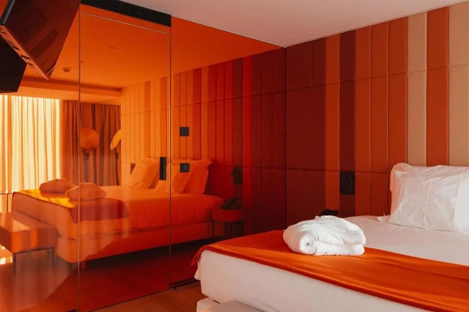 Indulge in a dramatic, design-forward bedroom with warm tones.